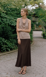Woman modeling taupe draped cowl neck sleeveless top