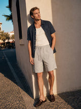 Man modeling light beige elastic waist shorts