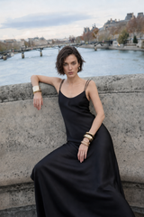 Woman modeling black satin look spaghetti strap slip maxi dress